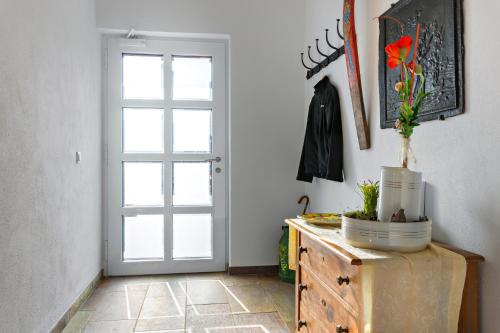 a room with a door and a dresser with a plant on it at Ferien Weingut Schneider in Ellenz-Poltersdorf