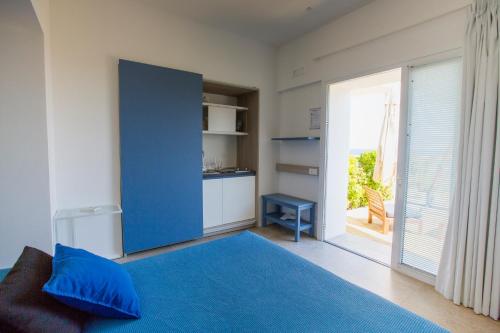 a bedroom with a blue bed with a blue pillow at A Tonnara in Cefalù