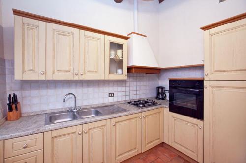 a kitchen with a sink and a stove at Borgo Nuovo San Martino in Ambra