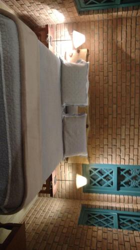 a bathroom with towels hanging on a wall at Pousada Pinho Bravo in Camanducaia