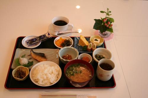 een dienblad met rijst en verschillende soorten voedsel erop bij Urban Hotel Sanko in Chiba