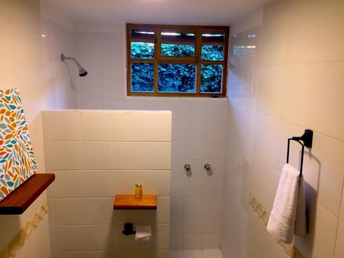 a bathroom with a shower and a window at Rukka Lodge in Tumbaco