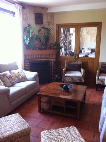 a living room with a couch and a coffee table at Casa Rural Alquería de Segovia in Tizneros