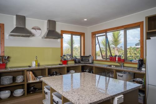 a kitchen with a large island in the middle at Eden's Edge Lodge in Motueka