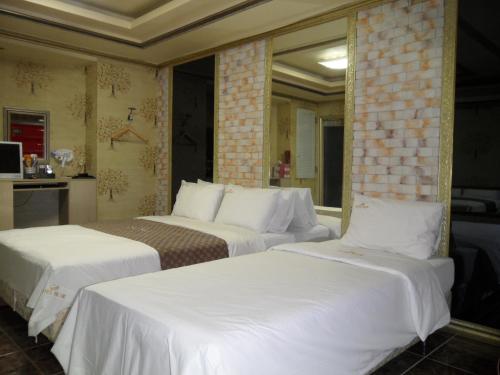 מיטה או מיטות בחדר ב-Songdo Blue Hotel