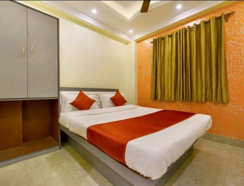 a bedroom with a large bed in a room at Golden Heaven Hotel in Kolkata