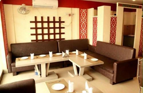 a living room with a couch and a table at Golden Heaven Hotel in Kolkata