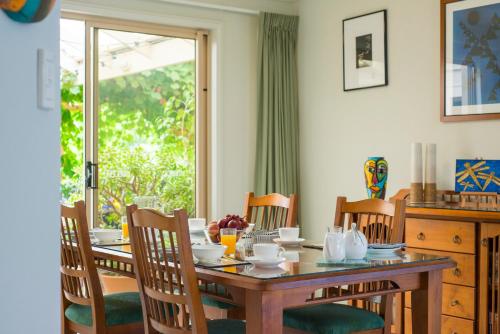 a dining room with a table and chairs and a window at Bellevue Bed & Breakfast in McLaren Vale