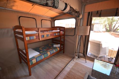 a bedroom with two bunk beds in a room at Coalmine Beach Holiday Park in Walpole