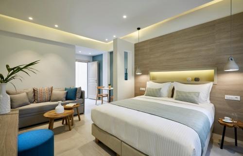 a hotel room with a bed and a couch at Fileria Suites in Oia