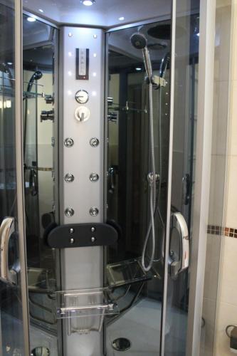 a shower in a bathroom with a glass wall at Tortugas B&B in Giarre