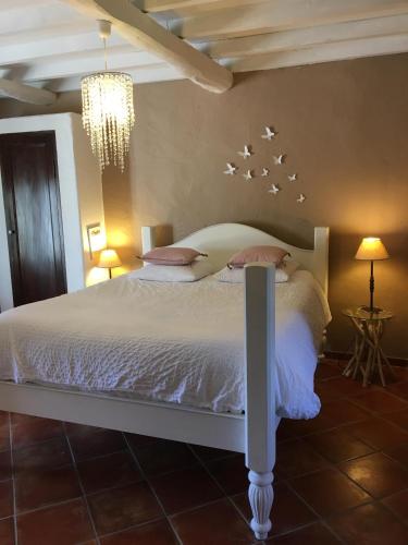 a bedroom with a white bed with stars on the wall at chambres d hotes Le Mas Julien piscine chauffée adult only in Orange