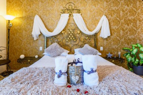 a bedroom with a bed with white boots on it at Pensiunea Avy in Haţeg
