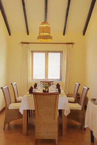a dining room with a table and chairs at Pinewood Beach Resort and Spa in Diani Beach