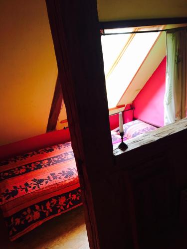 a small room with a bed and a window at Baltā māja in Pilsrundāle