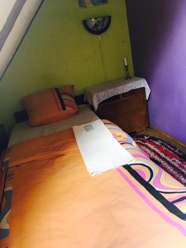a bedroom with a bed and a clock on the wall at Baltā māja in Pilsrundāle