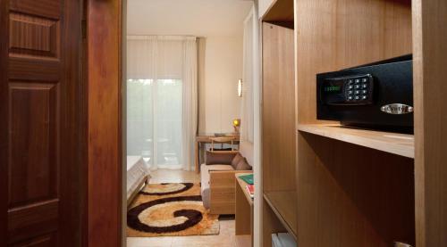 a small room with a door leading to a bathroom at Le Palmiste Resort & Spa in Trou aux Biches