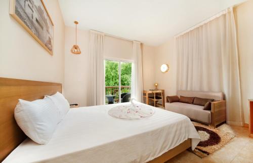 A bed or beds in a room at Le Palmiste Resort & Spa