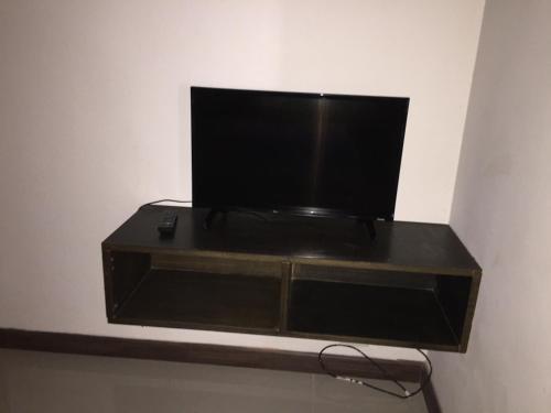a television sitting on a shelf in a room at Shanghai Guesthouse Monna bar in Pattaya Central