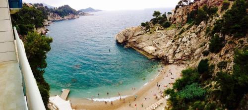 a group of people on a beach near the water at Magellan Deluxe One in Dubrovnik