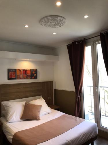 a bedroom with a large bed and a window at Grand Hotel Nouvel Opera in Paris