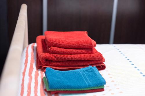a pile of towels sitting on top of a bed at Cozy fisherman's house in Valencia