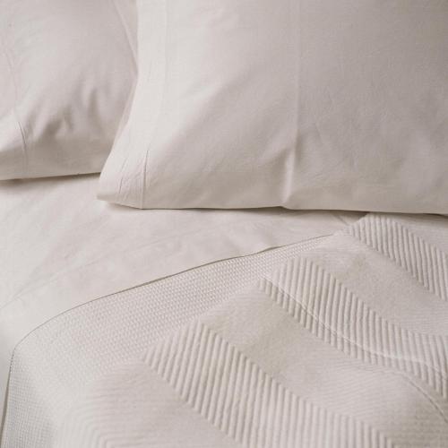 an unmade bed with white sheets and pillows at Palacio De Los Navas in Granada