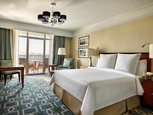 a hotel room with a large bed and a desk at Four Seasons Hotel Cairo at Nile Plaza in Cairo