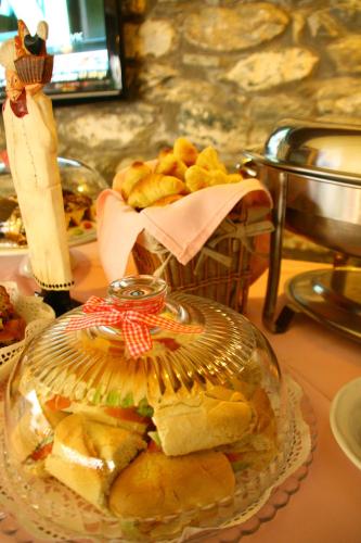 a plate of sandwiches and a basket of bread at Boutique Hotel Kentrikon & Bungalows in Agios Ioannis Pelio
