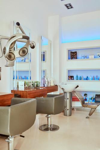 a salon with chairs and a table and a lamp at Grecian Park in Protaras