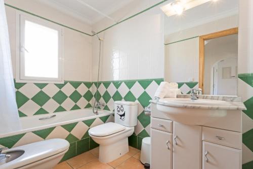 a bathroom with a white toilet and a sink at Monte Violeta in Jávea