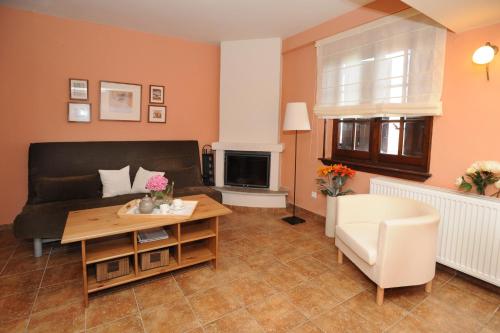 a living room with a couch and a table at Boutique Hotel Kentrikon & Bungalows in Agios Ioannis Pelio