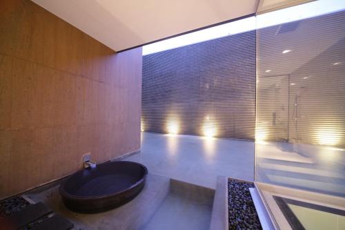 a bathroom with a tub in the corner of a room at Four Seasons Yuzawa Quattro in Yuzawa