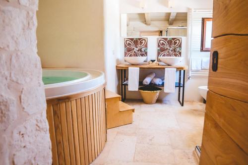 a bathroom with a sink and a tub in it at Materiis in Noci