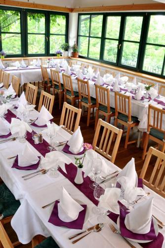 a large dining room with white tables and chairs at Stoffbauer GmbH in Graz