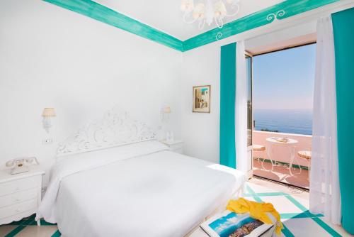 a bedroom with a bed and a view of the ocean at Villa Flavio Gioia in Positano