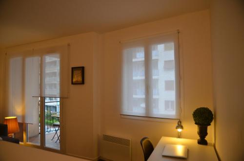 a room with a window and a table with a plant on it at Nice Promenade 1 in Nice