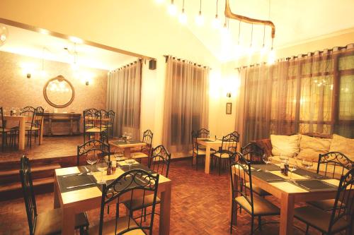 a dining room with tables and chairs and a room with at Boulevard Inn Mt Meru in Arusha