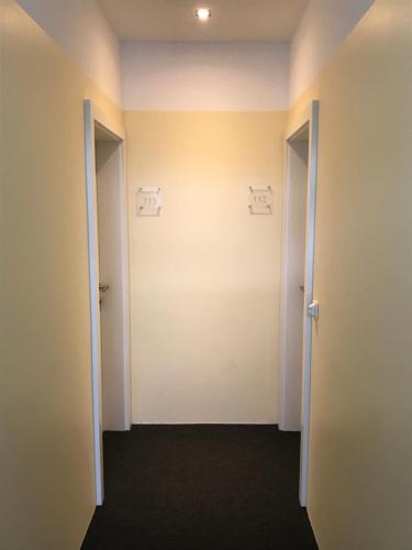 an empty room with two doors and a hallway at Business & City in Linz