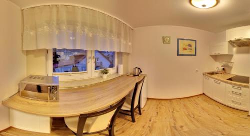 a kitchen with a large wooden table in a room at Apartamenty Pod Telegrafem in Kielce