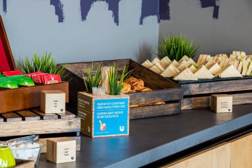 a counter with a display of bread and pastries at Urbihop Hotel in Vilnius