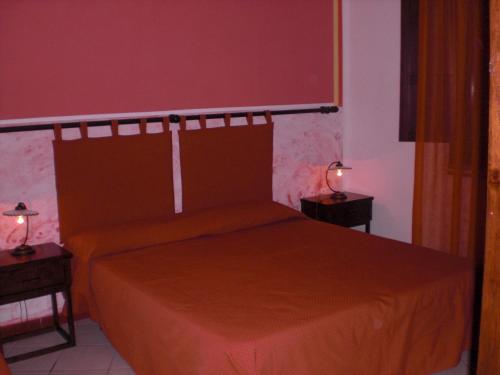 a bedroom with a bed and two night stands at A Giummara in Marsala