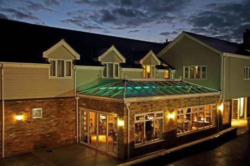 a large building with a green roof at night at The Anchor Ely in Ely