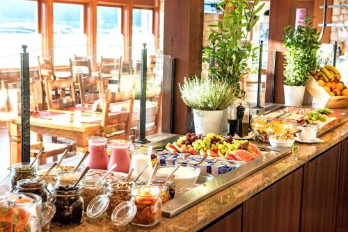 a buffet with fruit and other food on a counter at Hotel Szafran in Czeladź