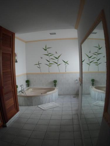 a bathroom with two tubs and two sinks at Vivienda vacacional Finca Ribera De Cortes in Nazaret