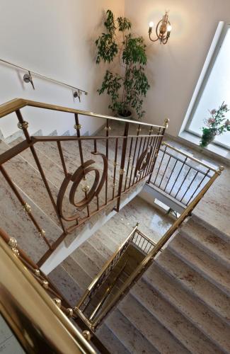 a set of stairs with a wrought iron railing at Hotel Hallerhof in Bad Hall