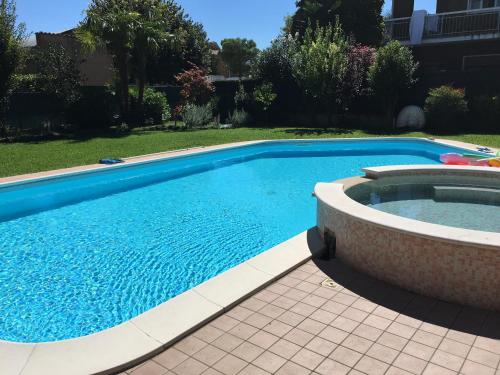 a swimming pool in a yard next to a house at B&B Villa Giulia in Desenzano del Garda
