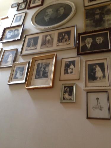 a wall full of pictures of people on a wall at B&B Silentium in Tielt