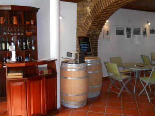 a room with two wine barrels and a table and chairs at Solar Dos Viscondes - Turismo De Habitacao in Ferreira do Alentejo