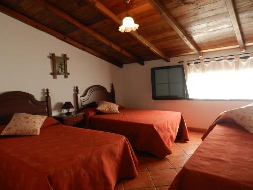 Ліжко або ліжка в номері Alojamiento Rural La Rabida 25